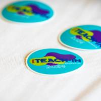 three blue stickers that read "Teach-In"